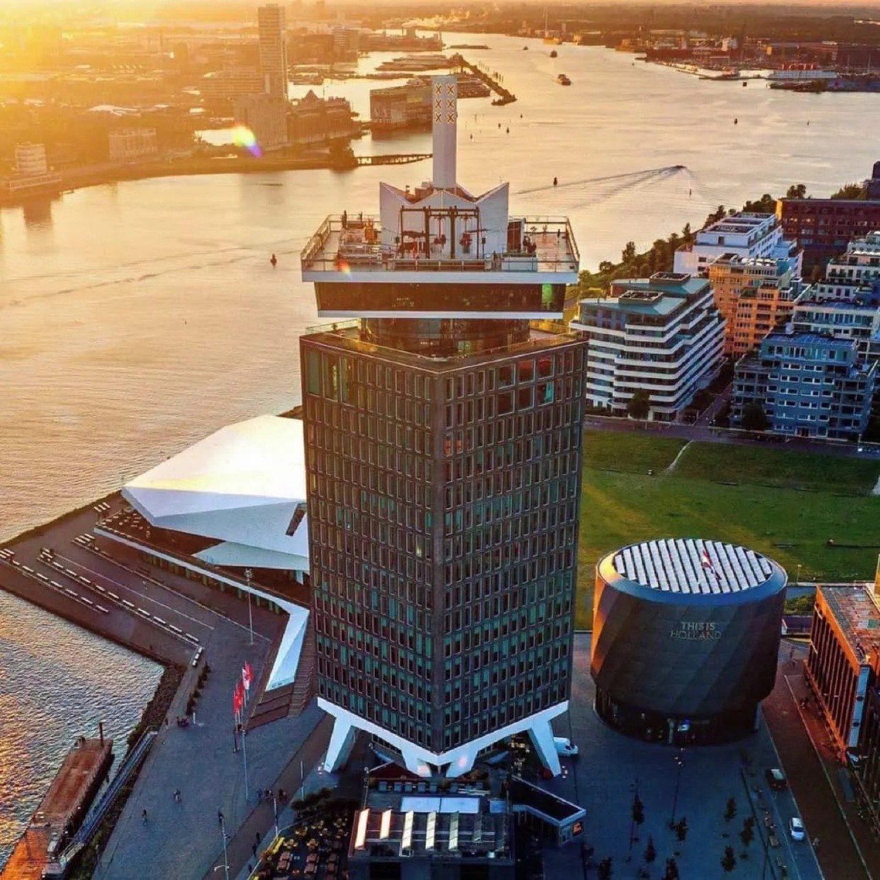 A’DAM Tower and Eye Filmmuseum beside the IJ at sunset.