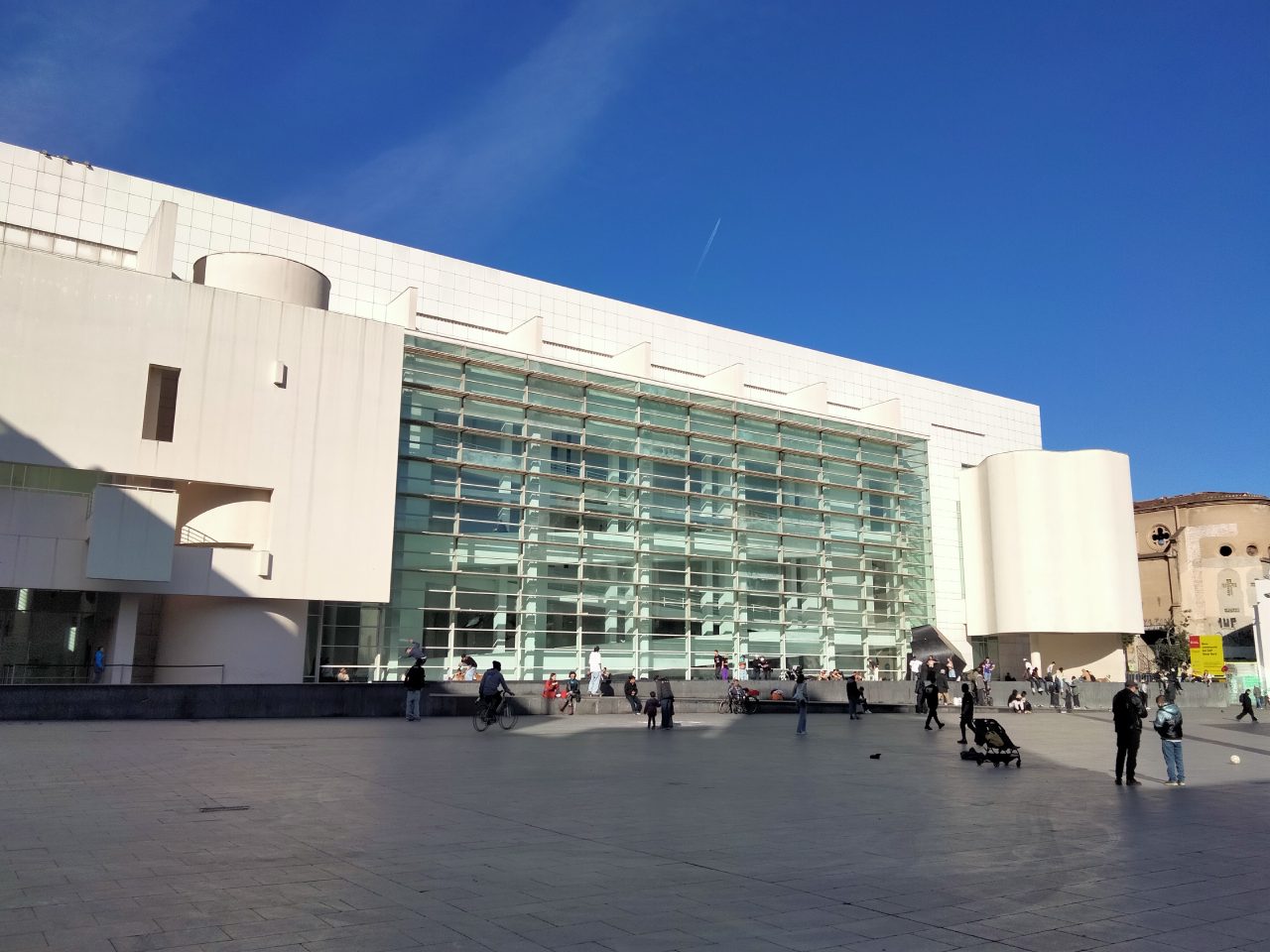 People in Plaça dels Àngels outside the white MACBA building in north Raval.