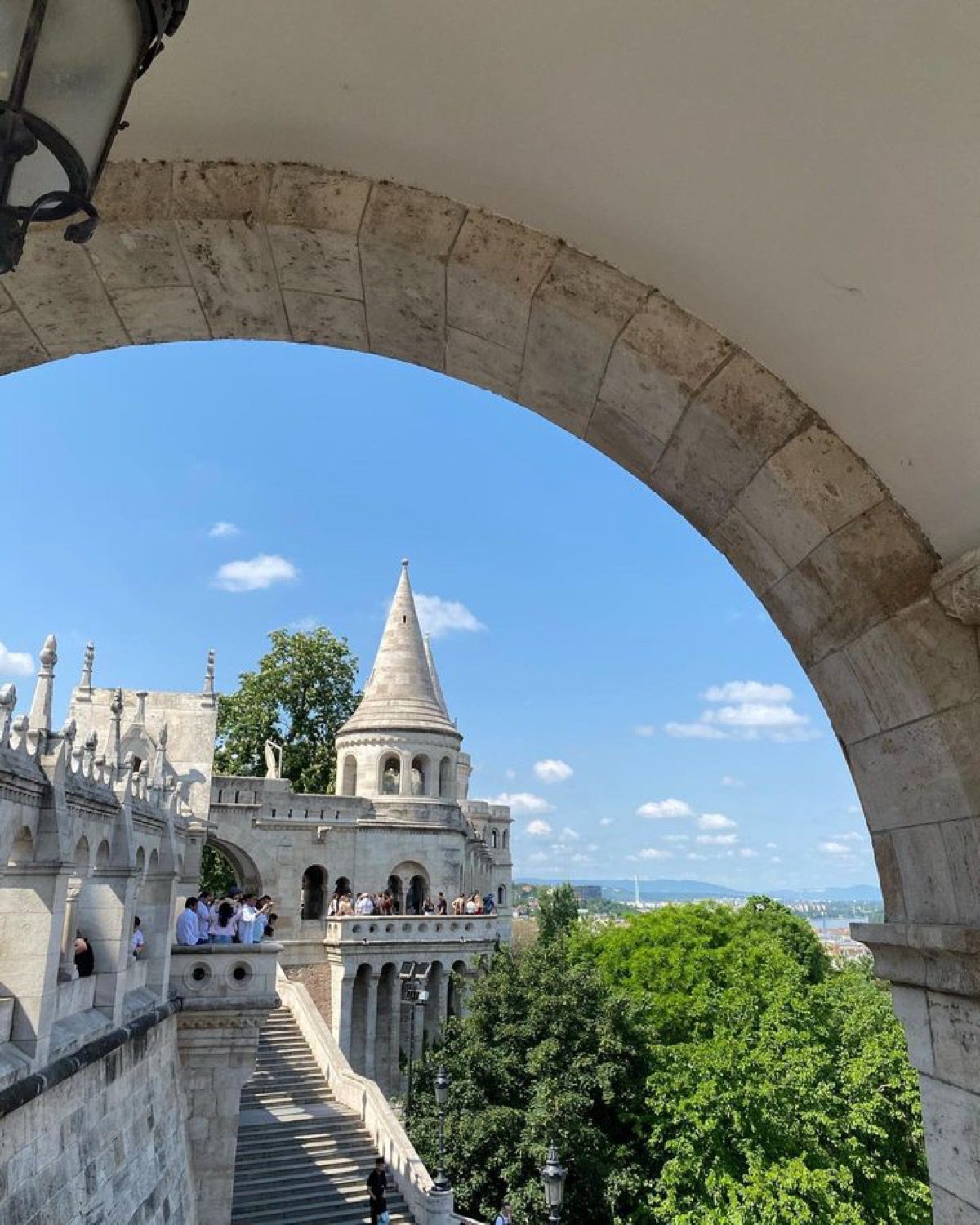 Fisherman’s Bastion turret and stairway framed by a stone arch.