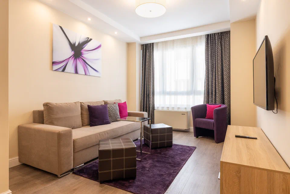 Sofa and low tables in a Silver Crown apartment living room.