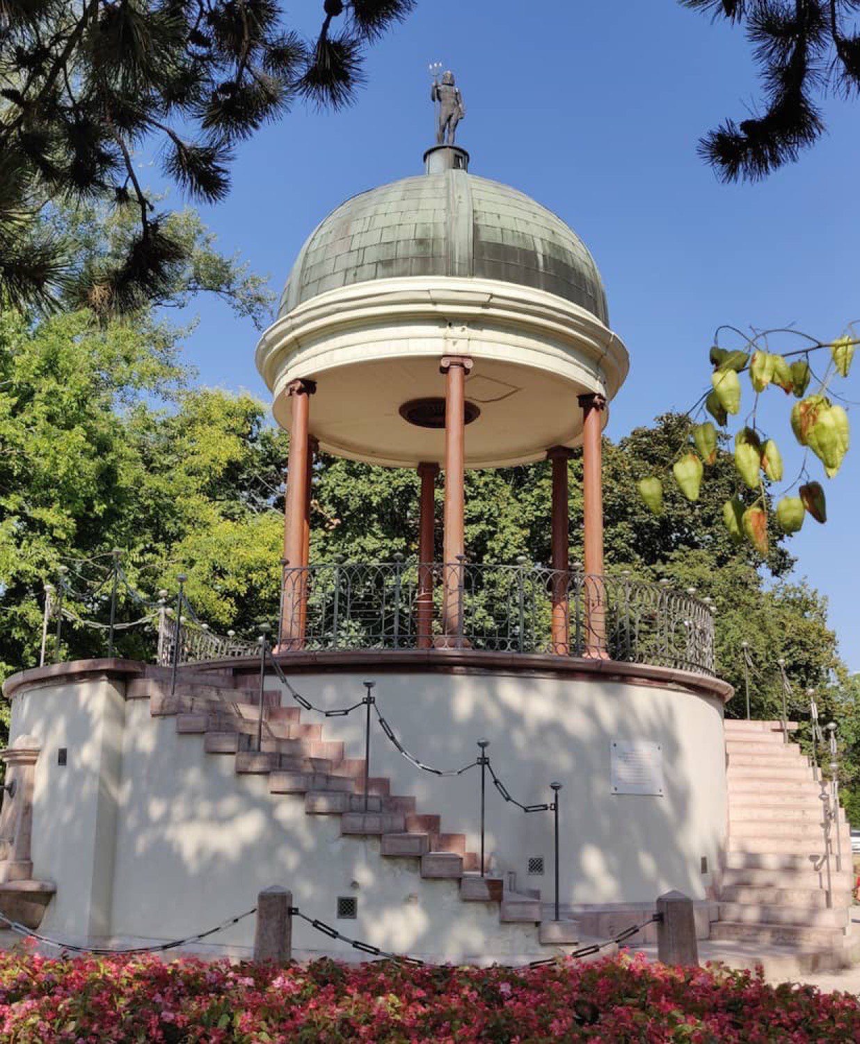 The Bodor music pavilion among trees and flowers on Margaret Island.