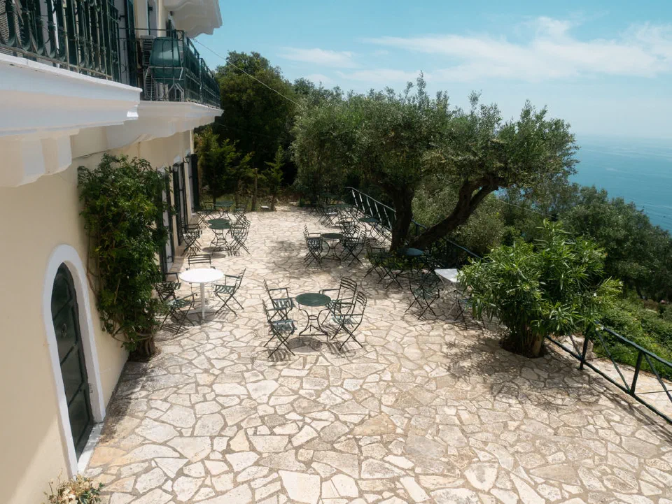 The stone terrace at Levant Hotel in Pelekas, with the sea far below.