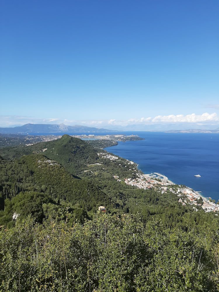 Corfu’s east coast seen from a hillside above the sea.