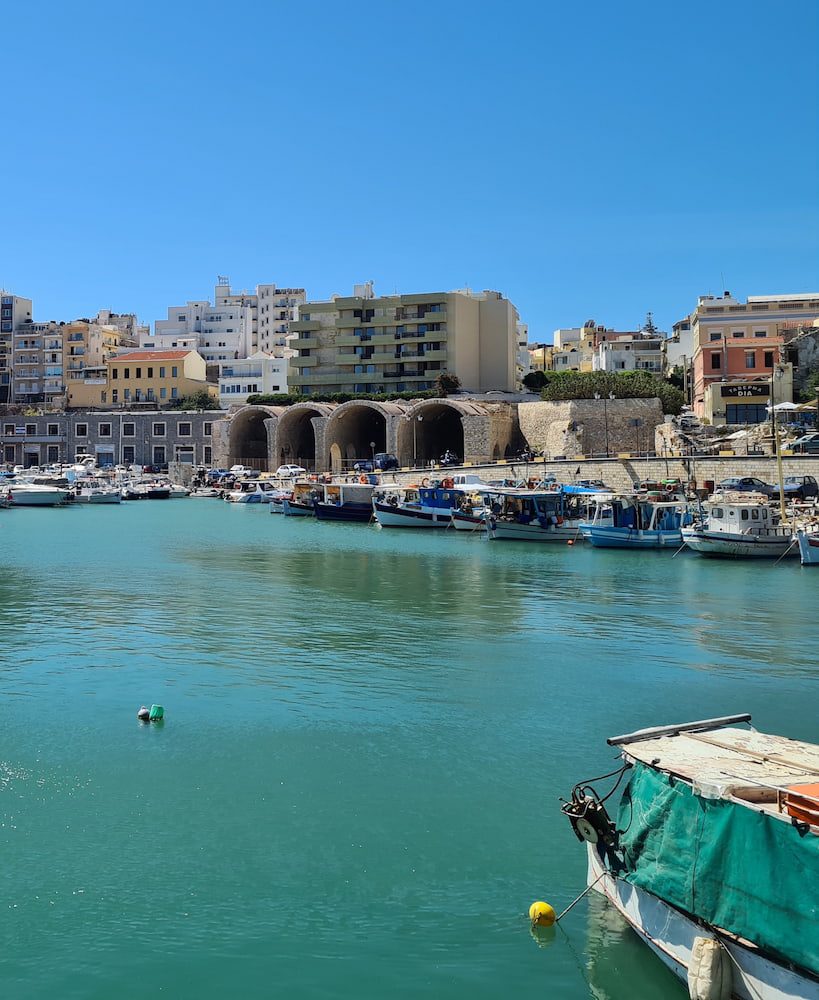 Fishing boats and stone-arched arsenals at Heraklion’s Venetian harbour.