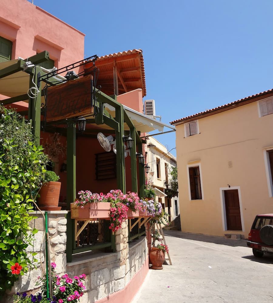 A flower-lined old-town lane and taverna in Rethymno.
