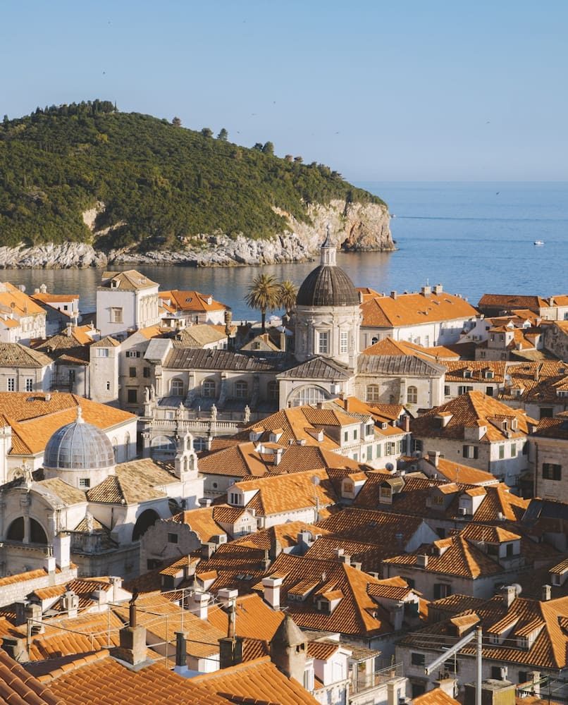 Dubrovnik’s Old Town rooftops with the cathedral dome and Lokrum in the distance.