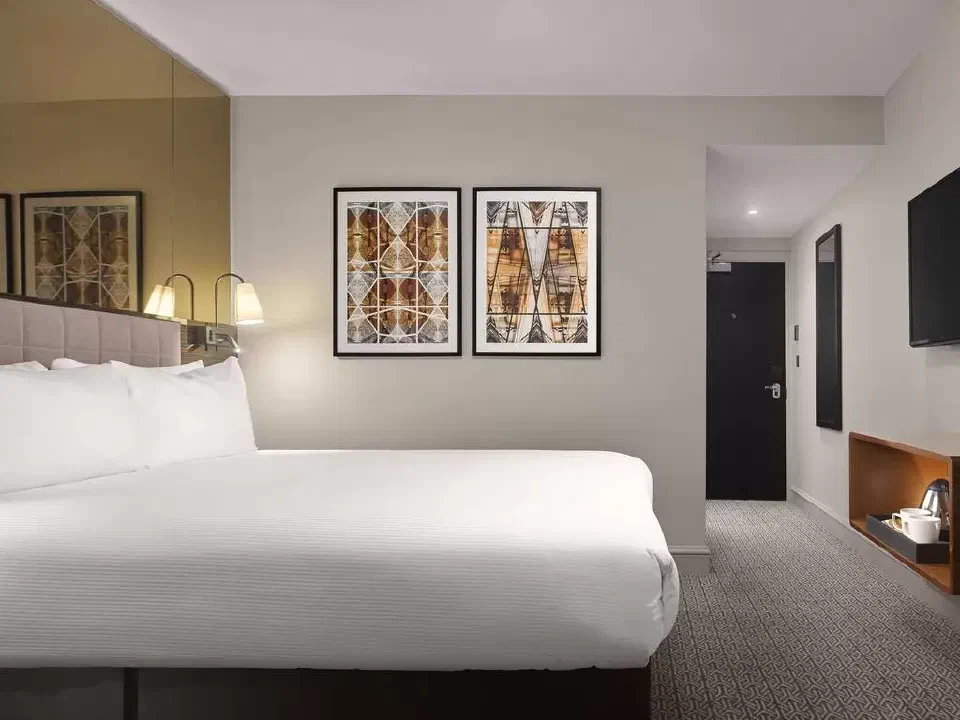 Superior Queen bedroom at Strand Palace with a queen bed, geometric artwork and a mirrored wall