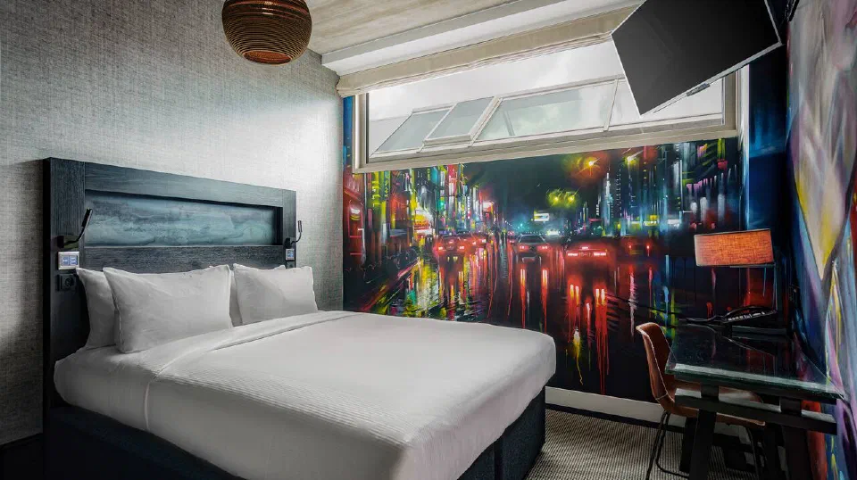 A Queen Guest Room at DoubleTree NDSM Wharf, with a colourful street-art mural beside the bed.