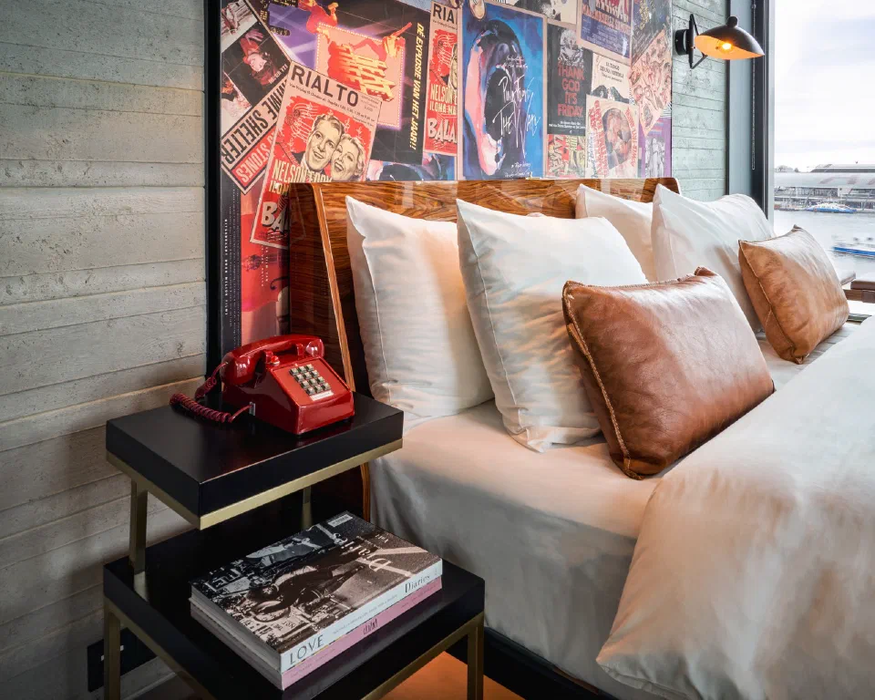 A Sir Adam bedroom with music posters behind the bed and a record player beside it.