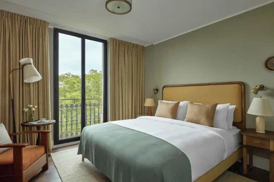 The Superior room at Miiro Borneta, with balcony doors and a reading chair.