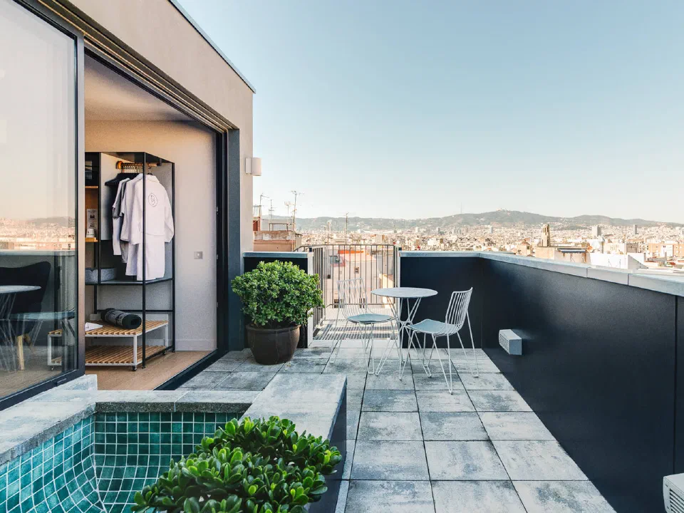Penthouse terrace at Hotel Brummell, with seating and an outdoor tub.
