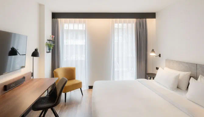 Superior room at Radisson Blu 1882, with a desk and window-side chairs.