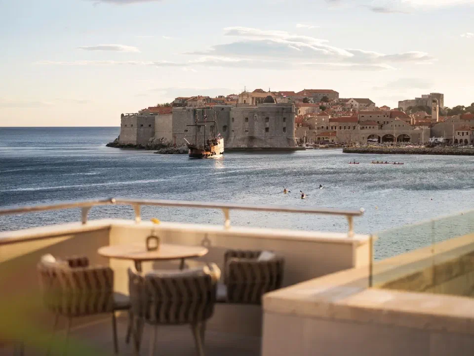 Hotel Excelsior's seafront terrace tables, with Dubrovnik's Old Town walls across the water.