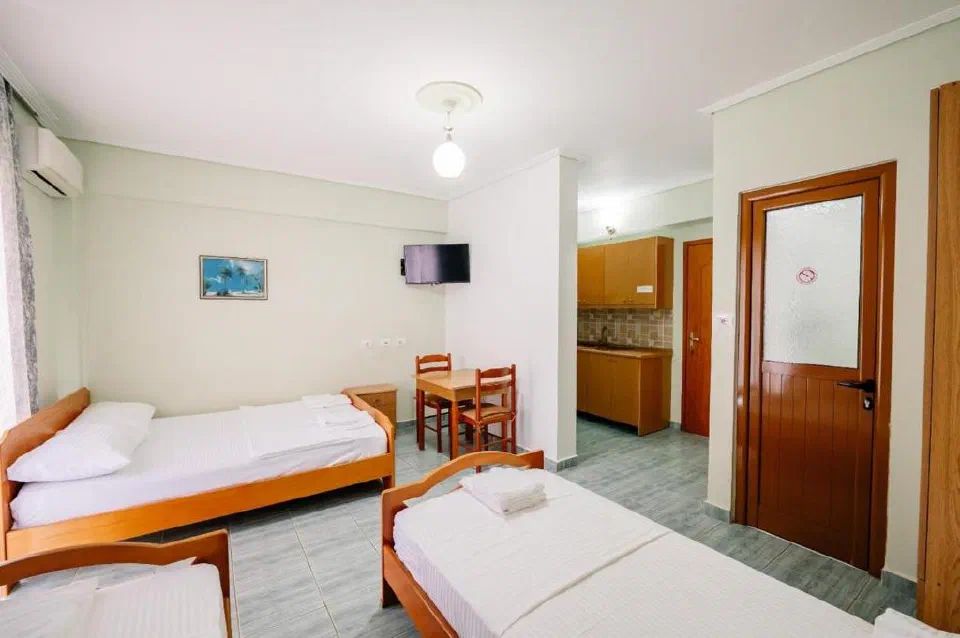 Sea Hotel family studio with several beds, a dining table and kitchenette.