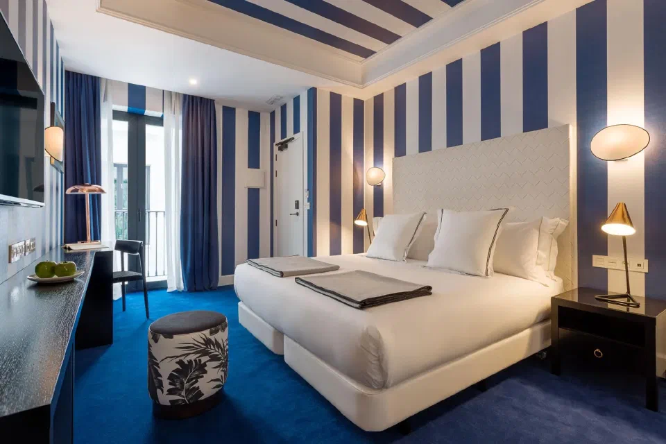 Blue-and-white striped Standard room at Room Mate Collection Valeria.