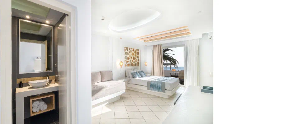 Liana Superior Room with Sea View, bed and balcony doors facing the Aegean