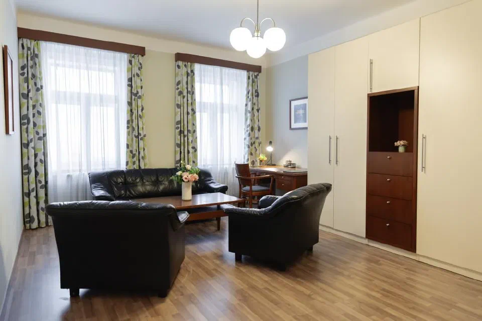 Living room seating and coffee table in Hotel Orion’s Family Apartment with Living Room.