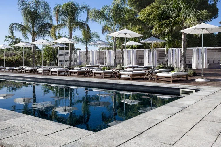 Shared Black Pool with loungers and umbrellas at La Suite Boutique Hotel