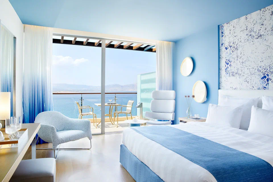 Blue-and-white Double Guestroom with a furnished sea-view balcony at Lindos Blu above Vlicha Bay.