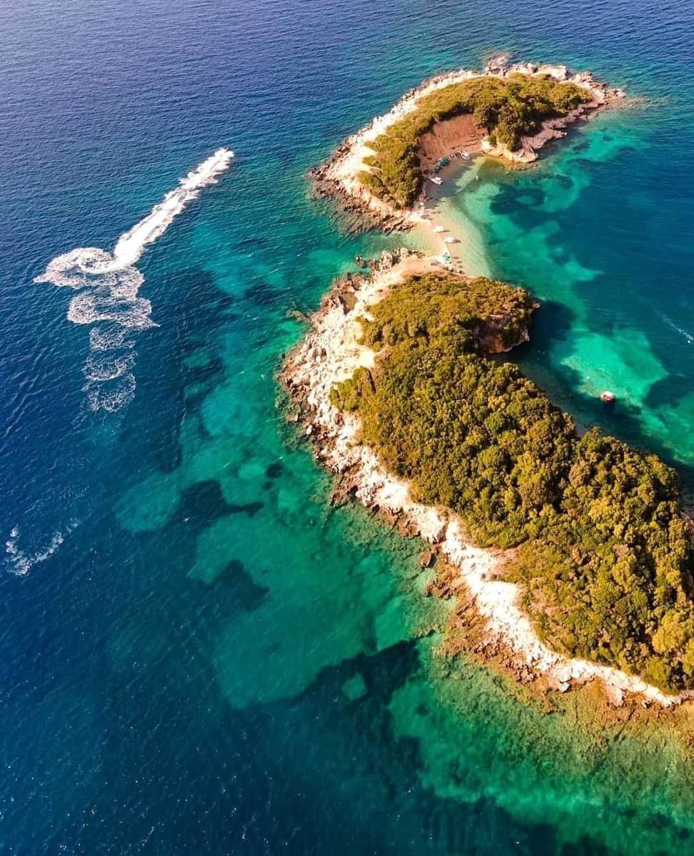 Ksamil's twin islets from above, joined by a strip of sand in green-turquoise water