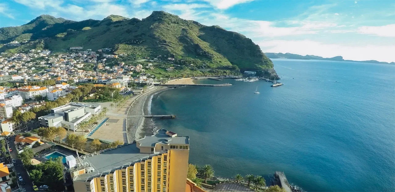 Machico Bay, its waterfront and hillside town, with Baía Madeira Hotel in the foreground
