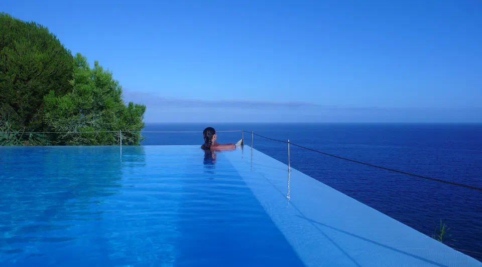 The outdoor infinity pool at Estalagem da Ponta do Sol overlooking the Atlantic.