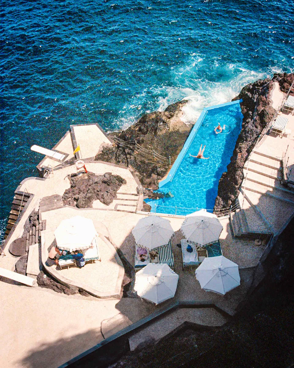 Reid’s Palace’s blue ocean-side pool between volcanic rocks and sun terraces.