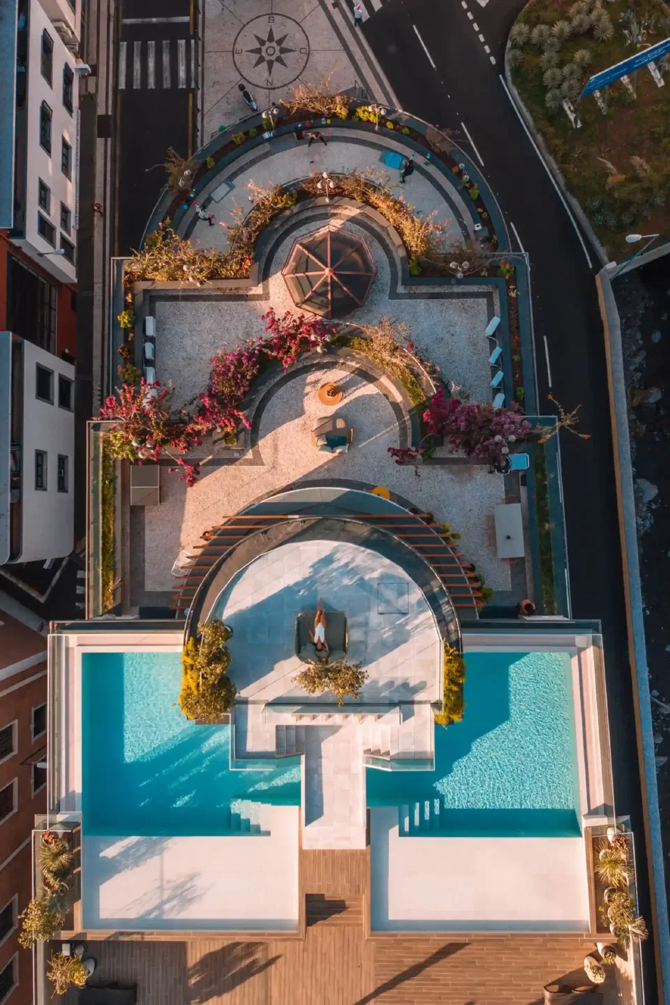 Aerial view of Three House Hotel’s rooftop pool and planted terrace in central Funchal.