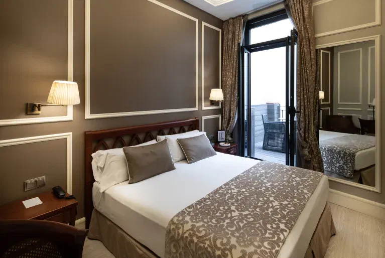 Catalonia Las Cortes Terrace Room: double bed and private terrace accessed through tall glass doors.