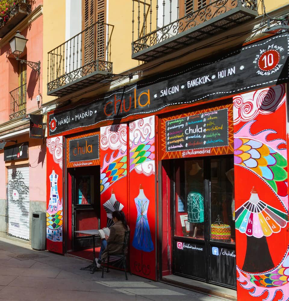A red painted boutique storefront on Calle del Dos de Mayo in Malasaña.
