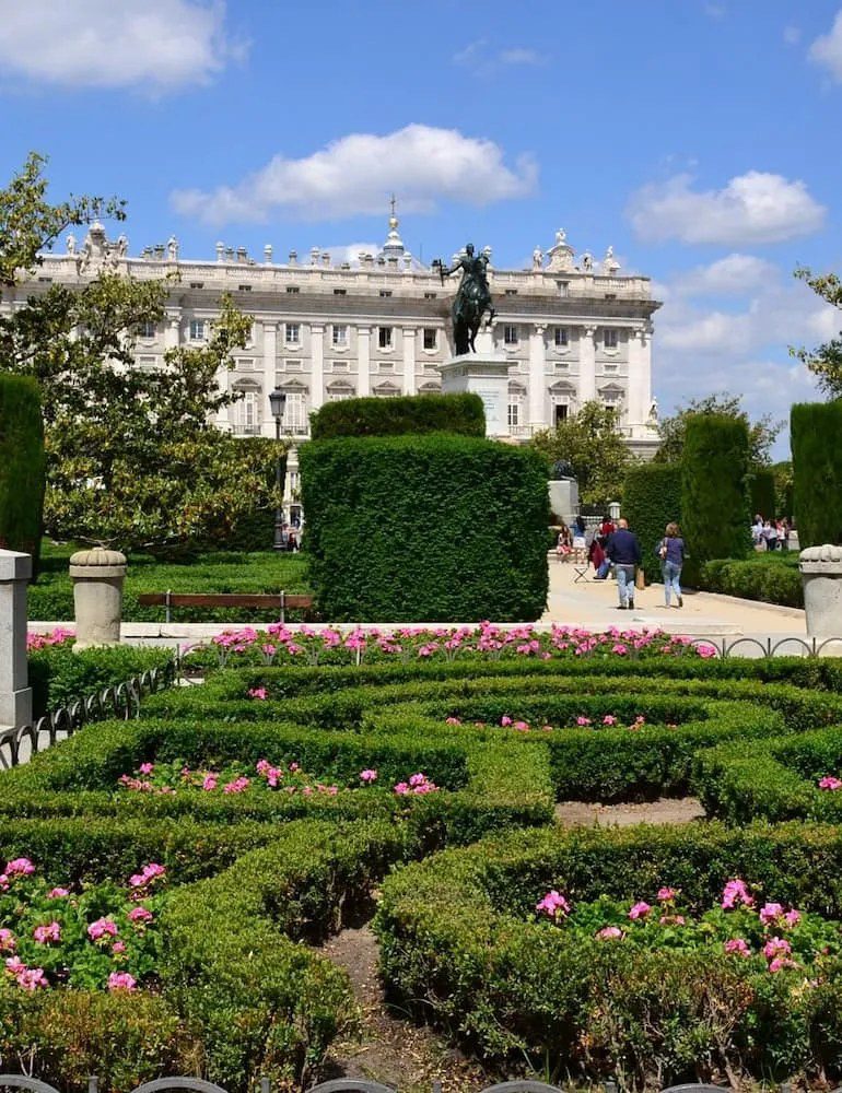 Formal gardens, the equestrian statue of Philip IV and the Royal Palace at Plaza de Oriente.