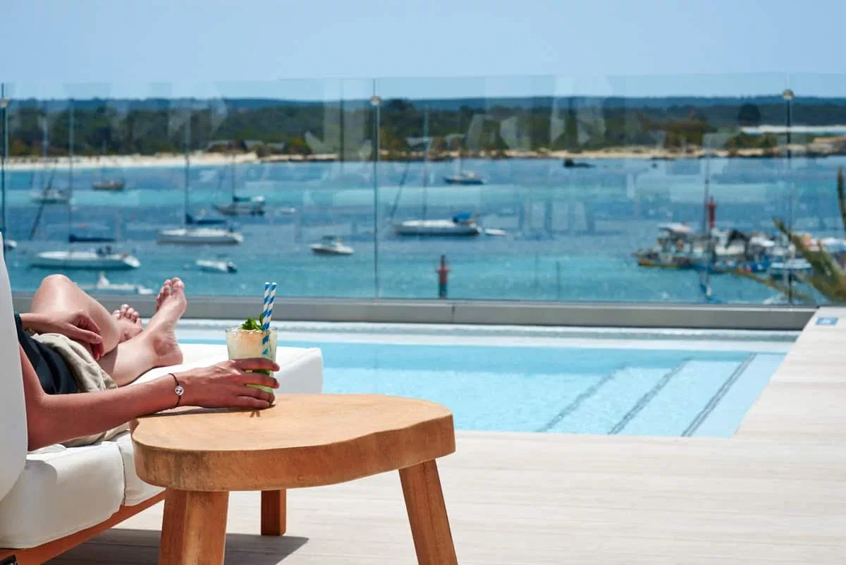 The harbour of Colònia de Sant Jordi seen past the rooftop plunge pool at Hotel Honucai.