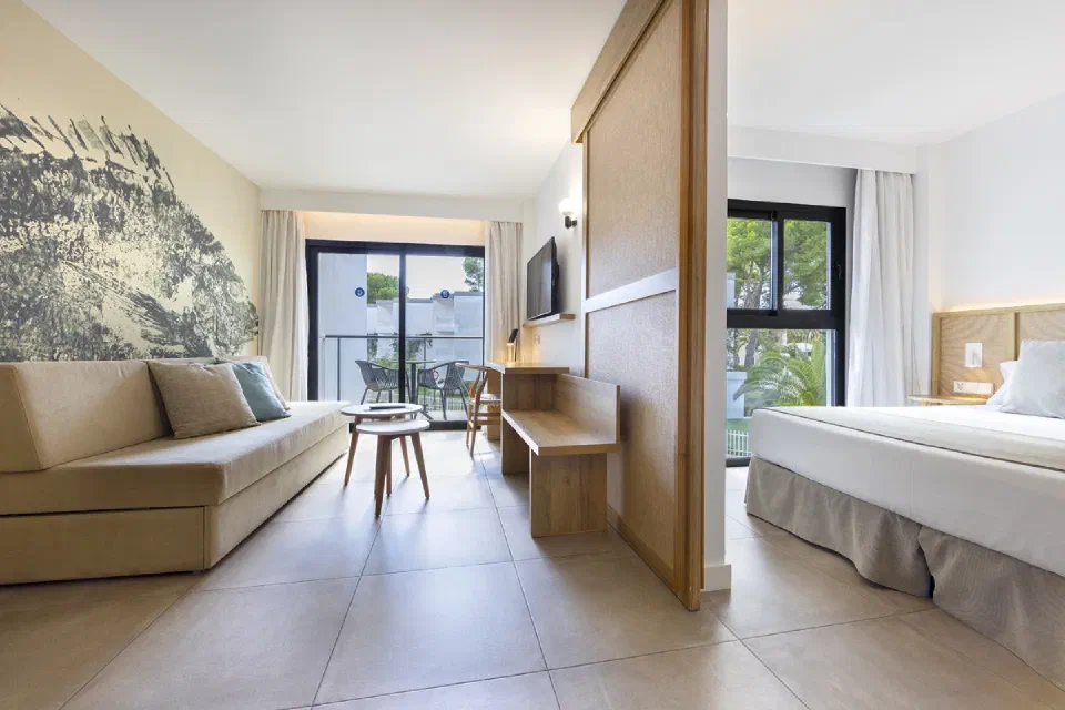 Sofa and balcony doors in an apartment at Sofia Alcudia Beach.