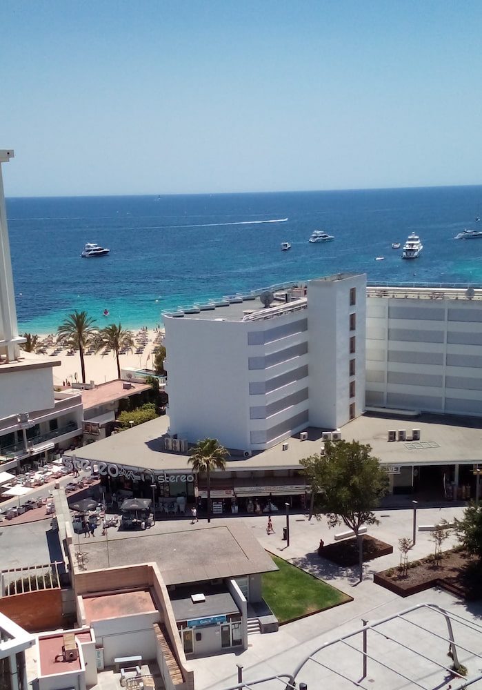 Buildings, promenade and beach at Magaluf, with the bay beyond.