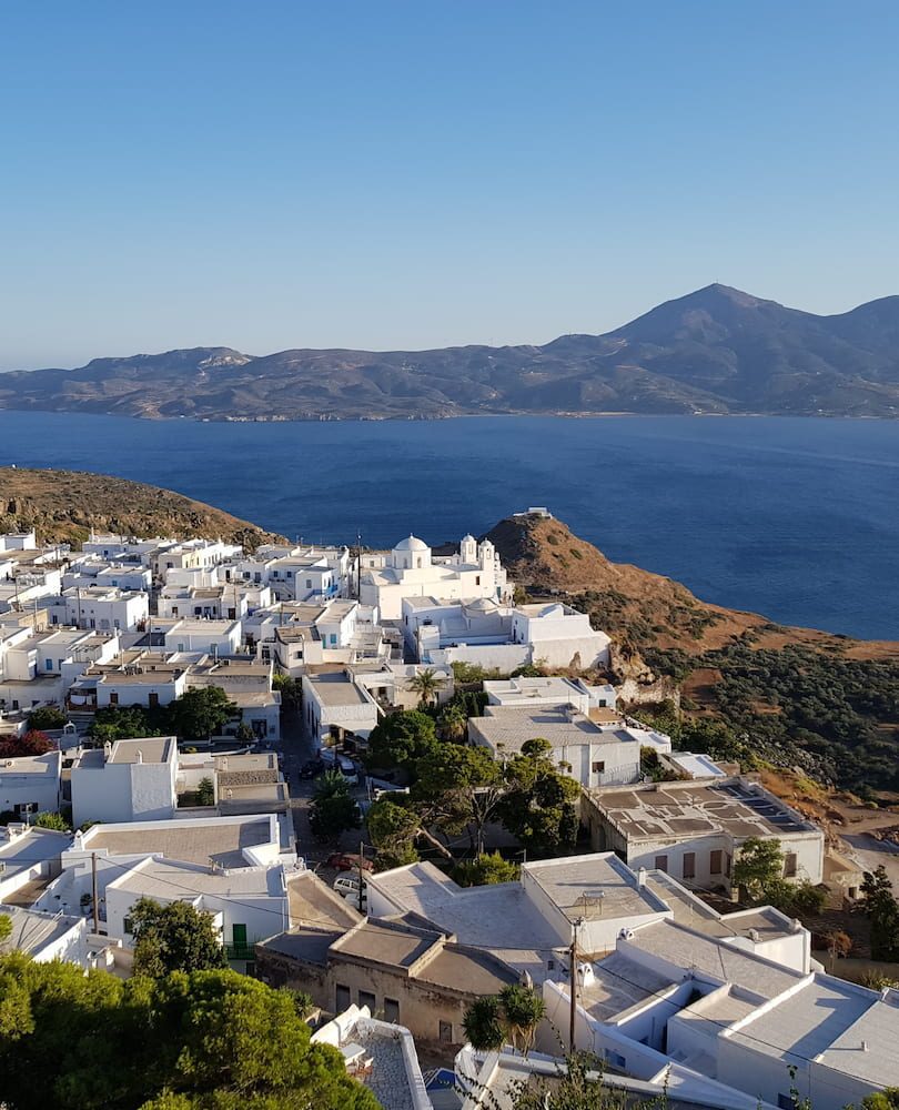 White village buildings on the hillside in Plaka, Milos.