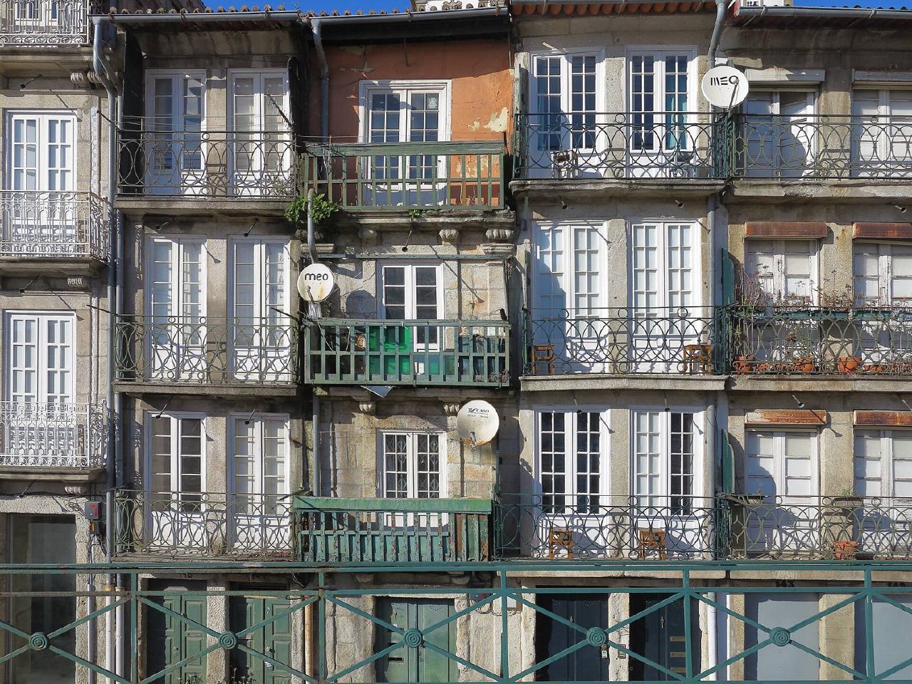 Colourful façades with iron and wooden balconies in Miragaia.