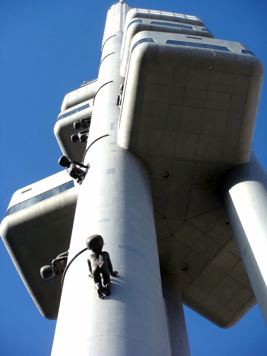 The Žižkov Television Tower with a crawling-baby sculpture on its column.