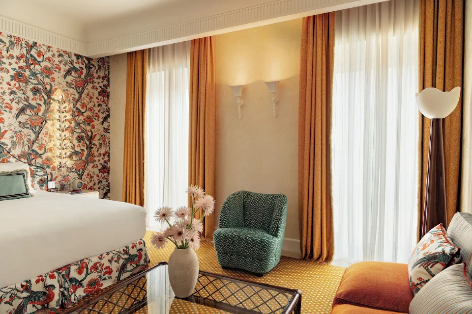 The colourful seating area and bed in a Junior Suite at Casa Monti Roma.