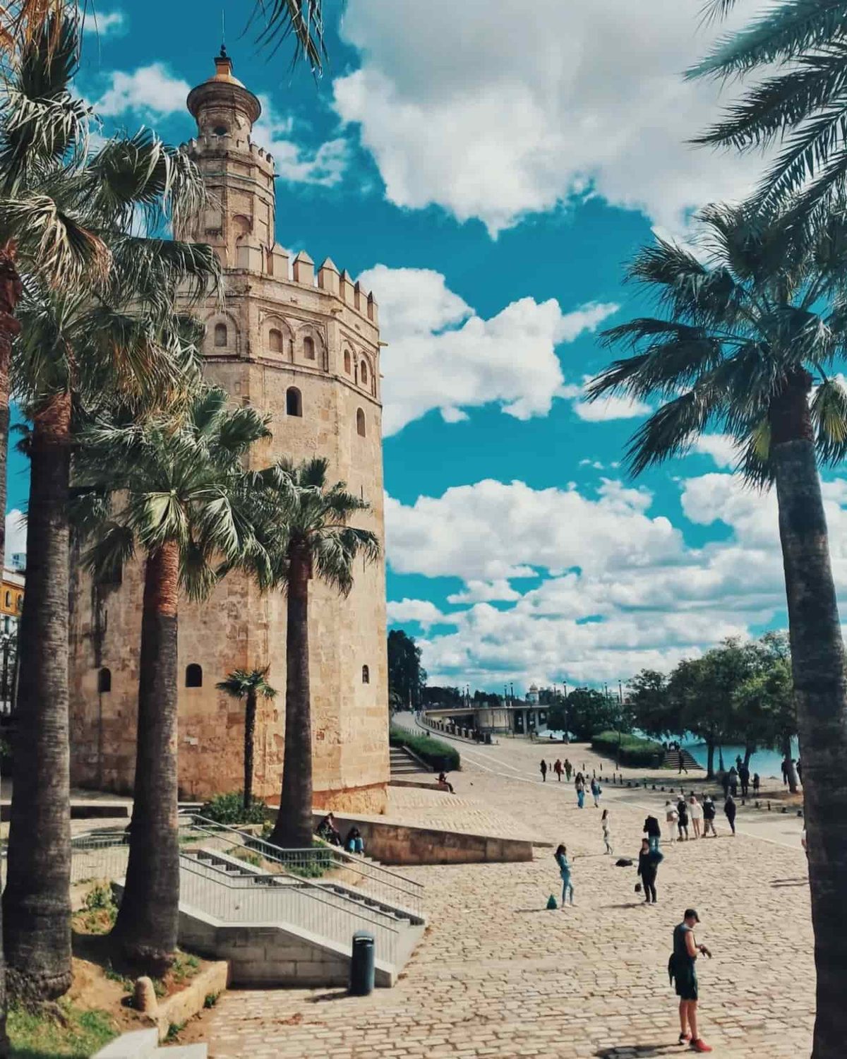 The Torre del Oro among palm trees beside the Guadalquivir in Seville’s Arenal quarter.