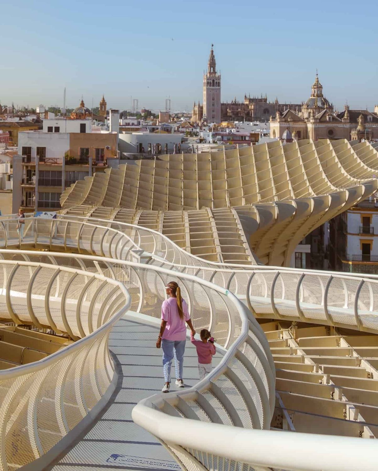 The walkway on the Setas de Sevilla, with the Giralda and city rooftops beyond.