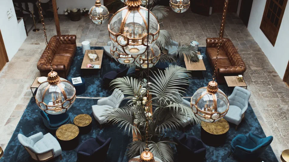 Glass lanterns, palms and seating in the historic lounge at La Laguna Gran Hotel.