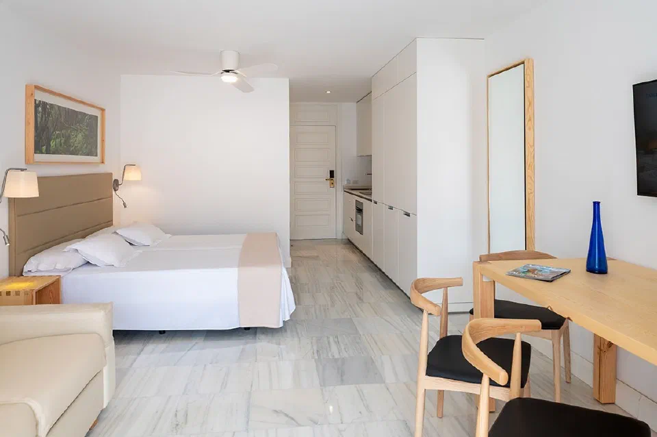 Bright Superior Studio at Parque Santiago IV with a bed, dining table and compact kitchen.