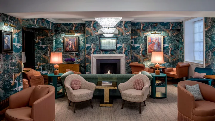 The Sitting Room at The Bloomsbury Hotel, with patterned walls and colourful lounge chairs