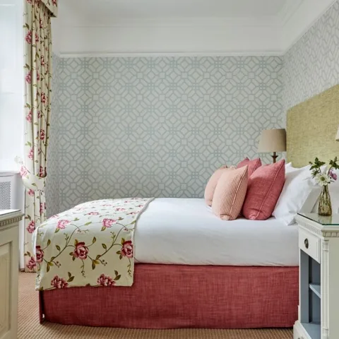 Double room at Durrants Hotel in Marylebone, with pink cushions and floral textiles