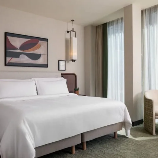 Iconic Executive bedroom at Montcalm Royal London House, with a king bed and floor-to-ceiling windows