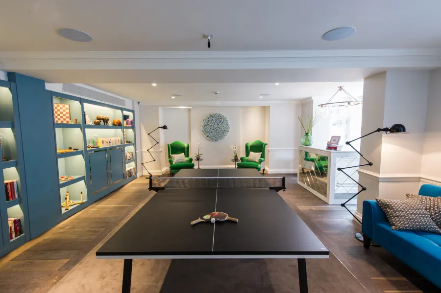 Games room with table tennis and green chairs at The Ampersand Hotel